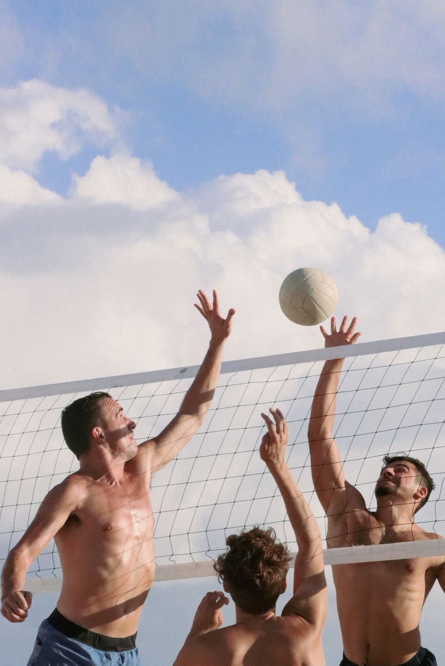 Shirtless Men Playing Beach Volleyball